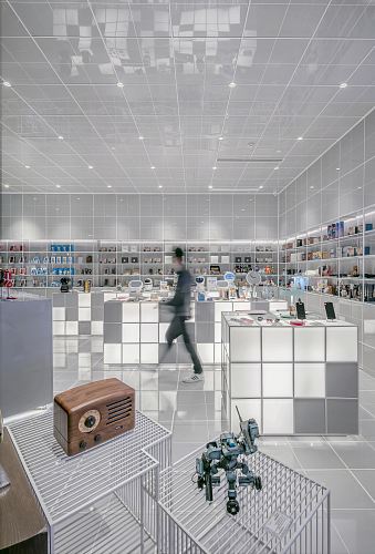 man walking beside white cube decoration